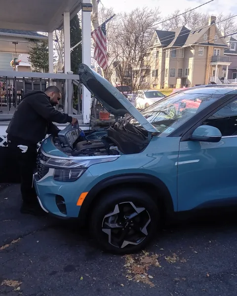 Steve checking over a Kia SUV in a driveway
